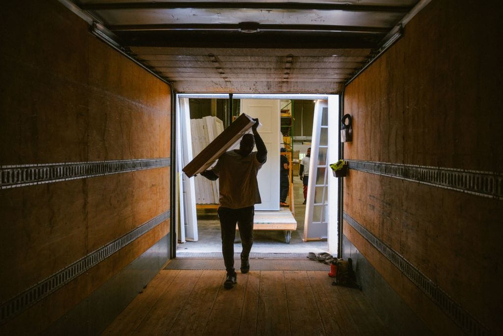 A Heavin team member loading a trim package into a delivery truck